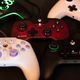 Five controllers for Xbox and PC are laid out on a rubber mat.